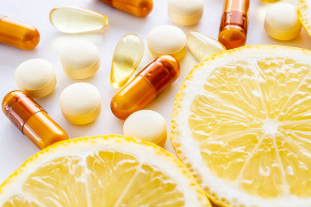 Slices of lemon and vitamin C supplements emphasize the importance of vitamin C in morning skincare routines.